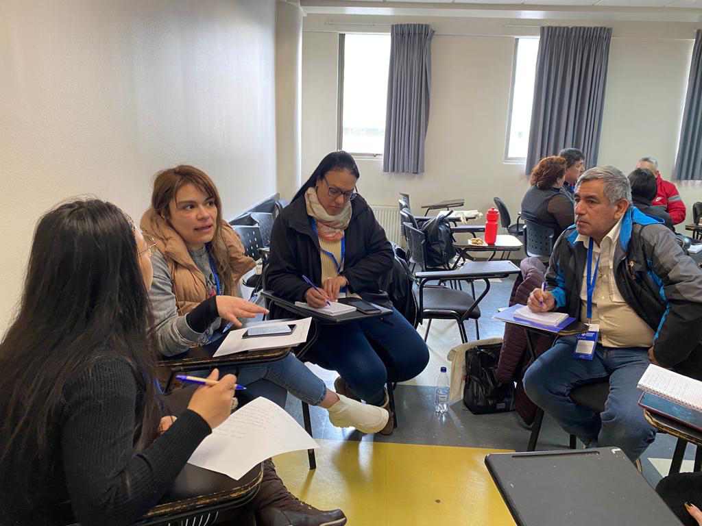 Participantes de la escuela de formación para asuntos migratorios sentados en una sala de clases