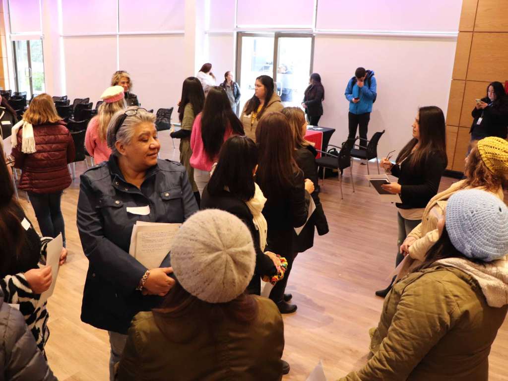 Mujeres compartiendo durante la ceremonia de entrega de certificaciones